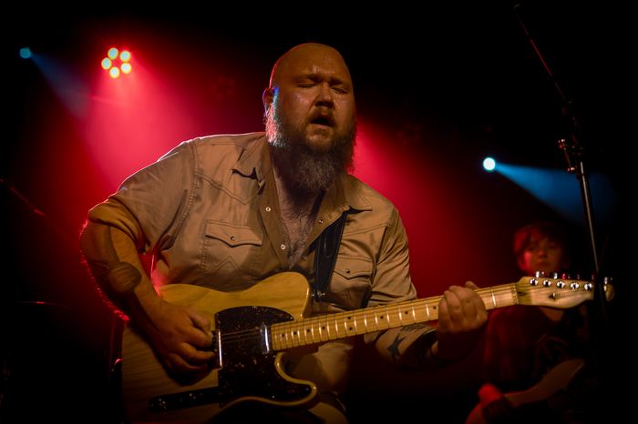 Ricky Ganiere plays guitar during the inaugural show.