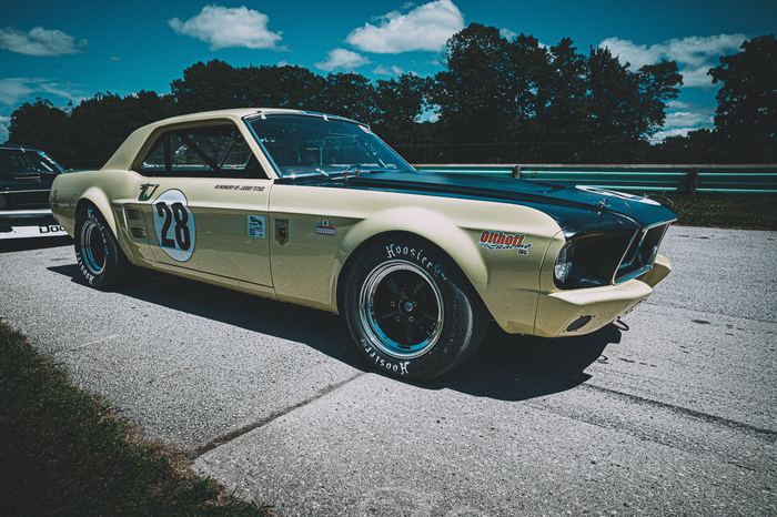 A 1967 Ford Mustang waits in the false grid for its turn on the track.