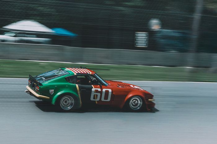 A colorful 1970 Datsun 2.8L 240Z stays on the gas through the end of the straightaway into turn 5 during Friday practice.
